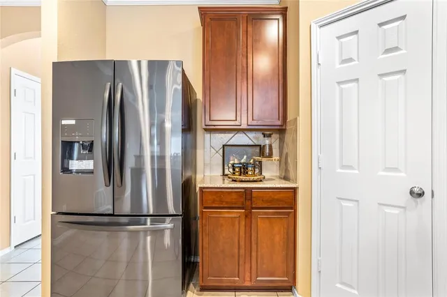 a kitchen with stainless steel appliances granite countertop a refrigerator and a stove top oven