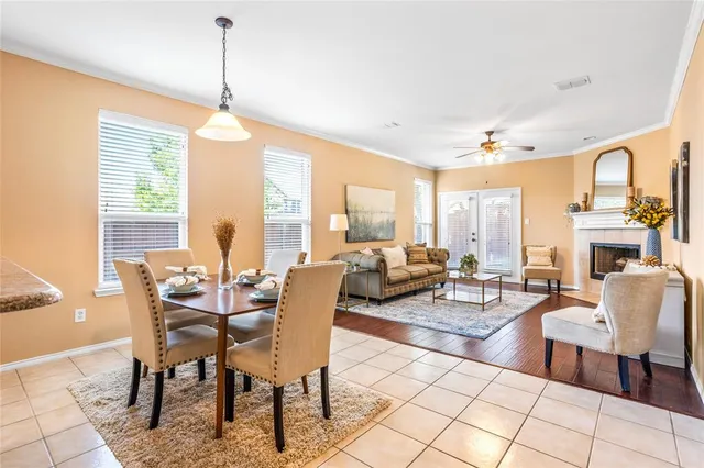 a living room with fireplace furniture and a large window