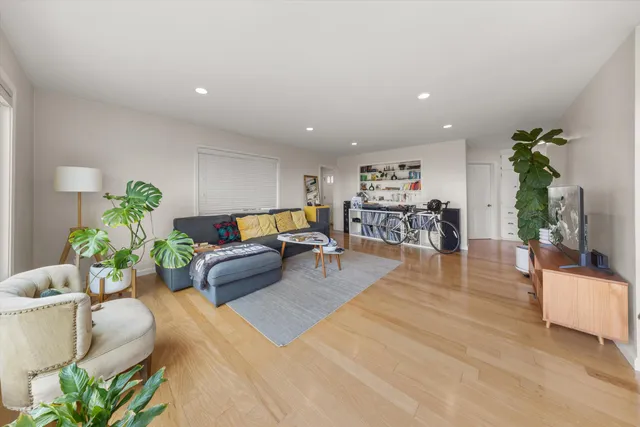 a open kitchen with stainless steel appliances granite countertop a stove and a refrigerator