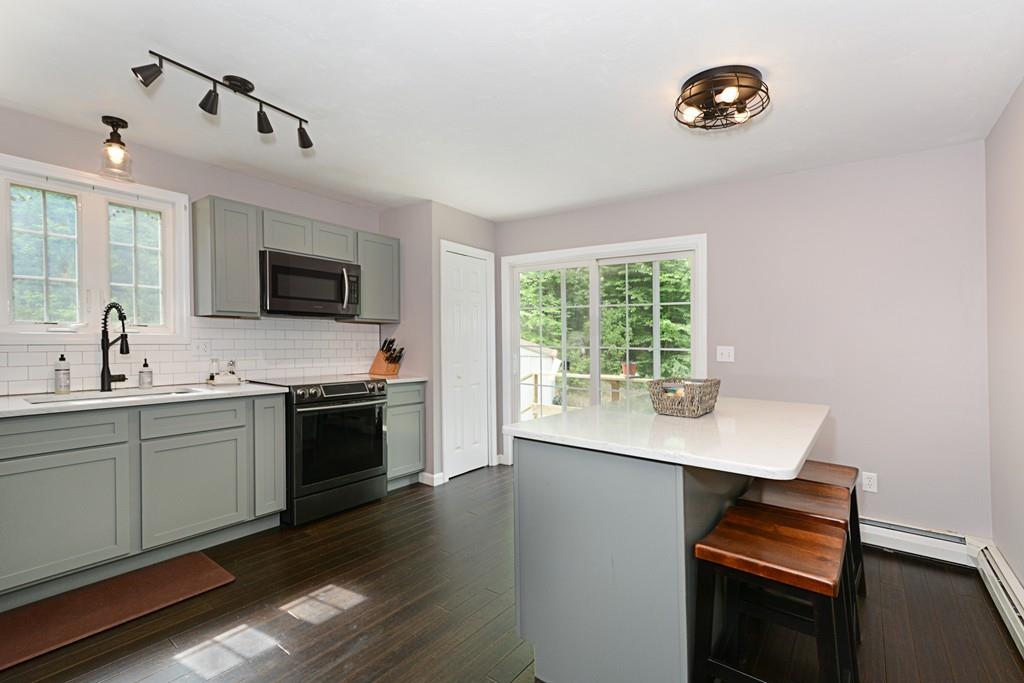 431 Barr Road New Braintree, MA 01531 - Photo 6 of 29 a kitchen with a stove and a microwave