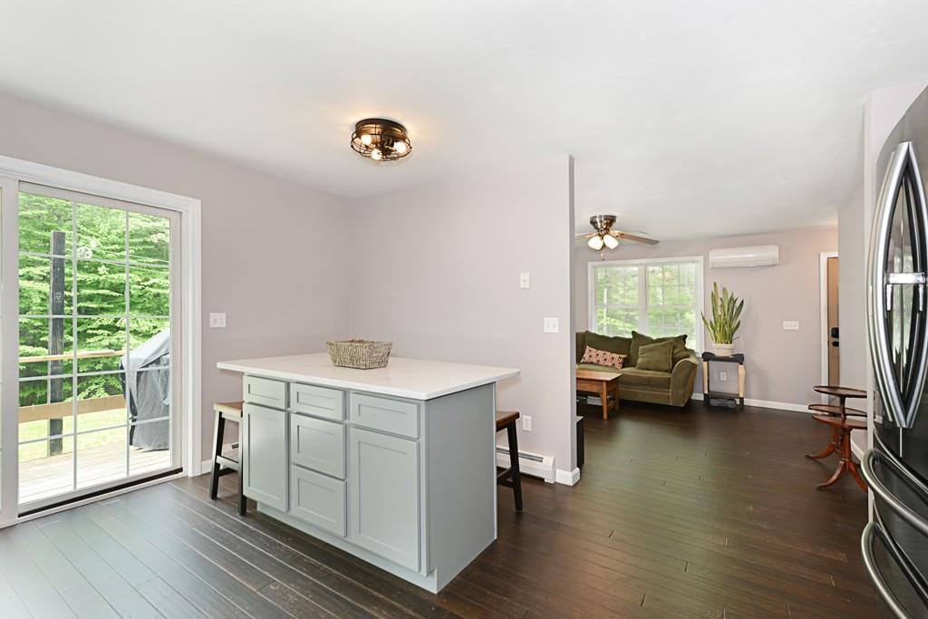 431 Barr Road New Braintree, MA 01531 - Photo 8 of 29 a kitchen that has a sink and a stove with wooden floor