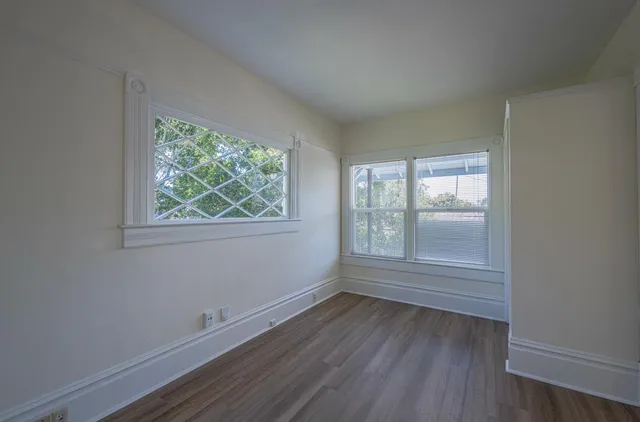 wooden floor in an empty room with a window