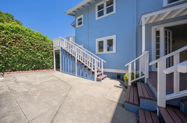 a view of a house with wooden fence