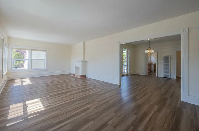 wooden floor in an empty room with a window