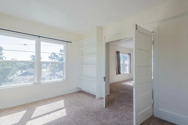 a kitchen with cabinets appliances a sink and a window