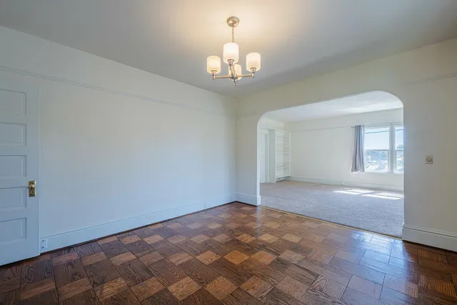 a view of an empty room with closet area