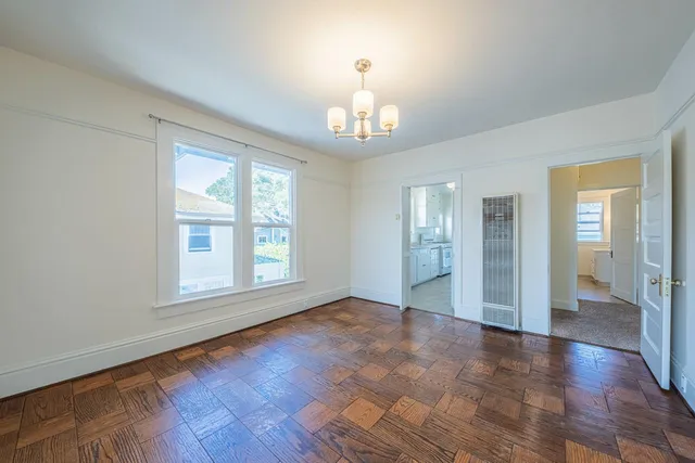 an empty room with windows and closet