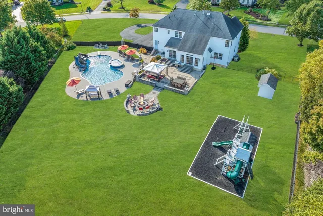 an aerial view of a house with garden space pool seating area and yard