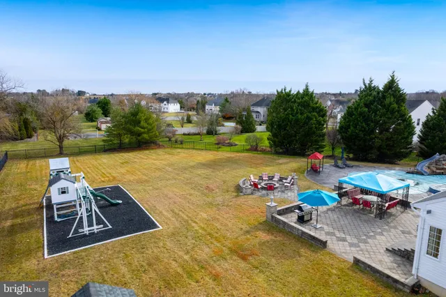 a view of yard and swimming pool in front of house