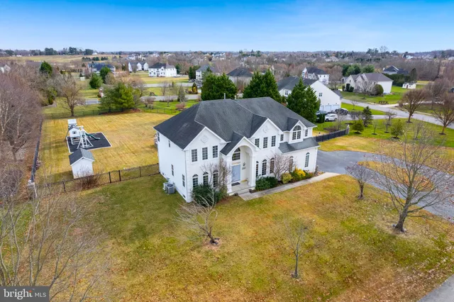 a view of residential houses with swimming pool and mountain view