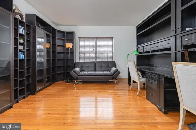 a living room with furniture a flat screen tv and a rug