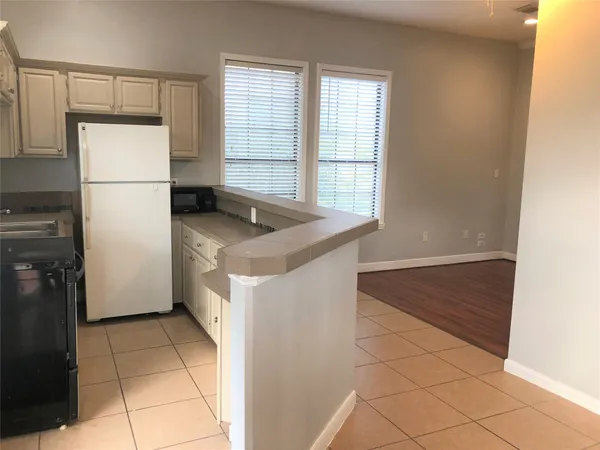 a kitchen with a stove a refrigerator and a sink