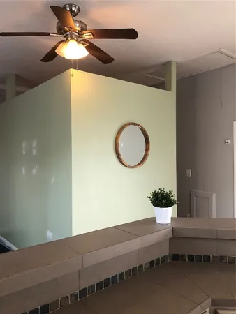 a kitchen with stainless steel appliances a sink a stove cabinets and a window