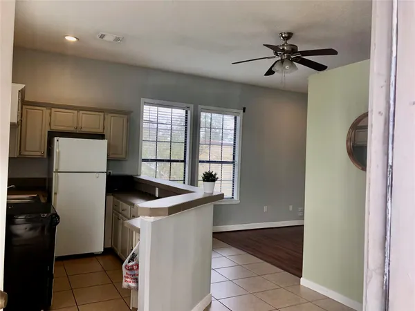 a kitchen with a refrigerator and a sink