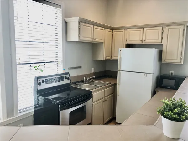 a kitchen with a stove and a refrigerator