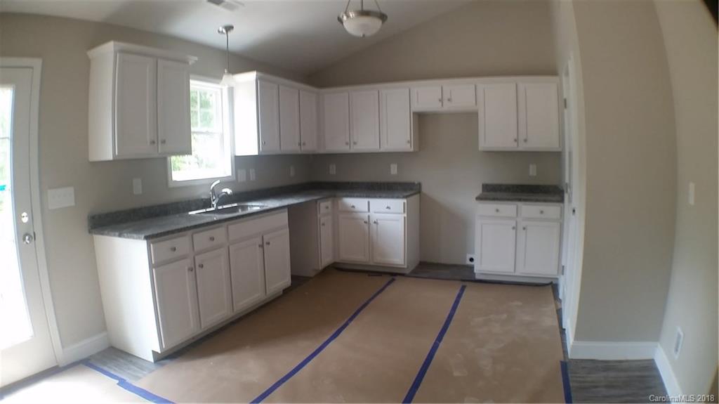 1815 Love Road Monroe, NC 28110 - Photo 2 of 9 a kitchen with stainless steel appliances granite countertop a stove a sink and a refrigerator