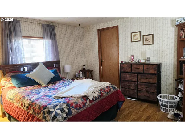 a bedroom with a bed and window