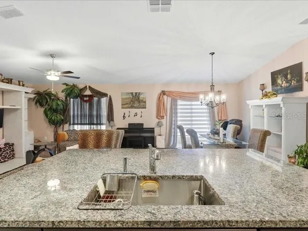 a kitchen with kitchen island granite countertop a sink and a counter top space