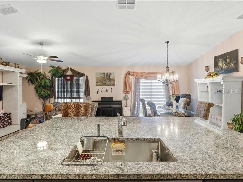 3943 Resting Robin Avenue Bartow, FL 33830 - Photo 12 of 38 a kitchen with kitchen island granite countertop a sink and a counter top space