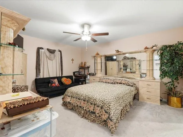 a bedroom with bed and a chandelier