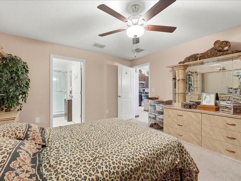 3943 Resting Robin Avenue Bartow, FL 33830 - Photo 15 of 38 a bedroom with a large bed and a chandelier