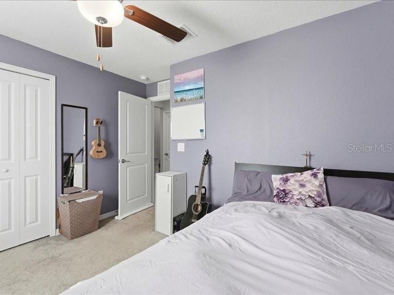 3943 Resting Robin Avenue Bartow, FL 33830 - Photo 19 of 38 a bedroom with a large bed and a chandelier