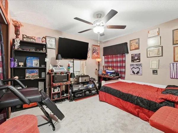 a bedroom with furniture and a flat screen tv