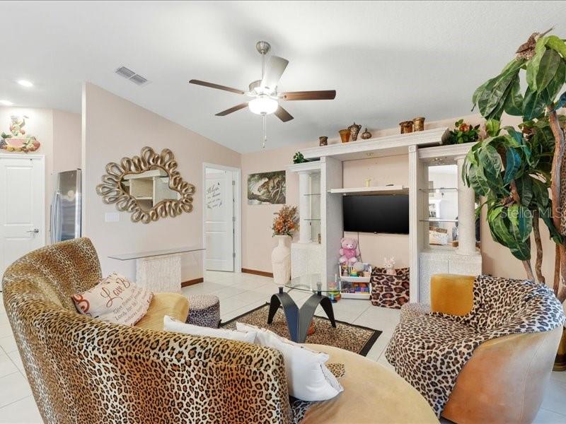 3943 Resting Robin Avenue Bartow, FL 33830 - Photo 3 of 38 a living room with furniture and a flat screen tv