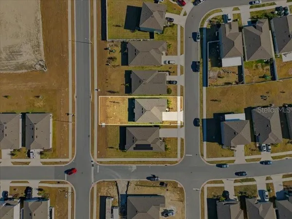 an aerial view of house with a parking space