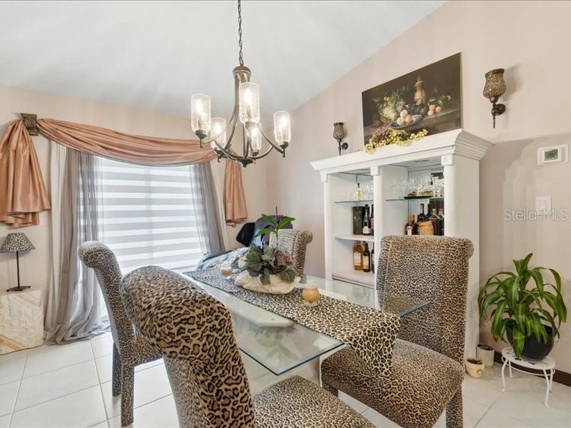 3943 Resting Robin Avenue Bartow, FL 33830 - Photo 5 of 38 a living room with furniture a chandelier and a flat screen tv