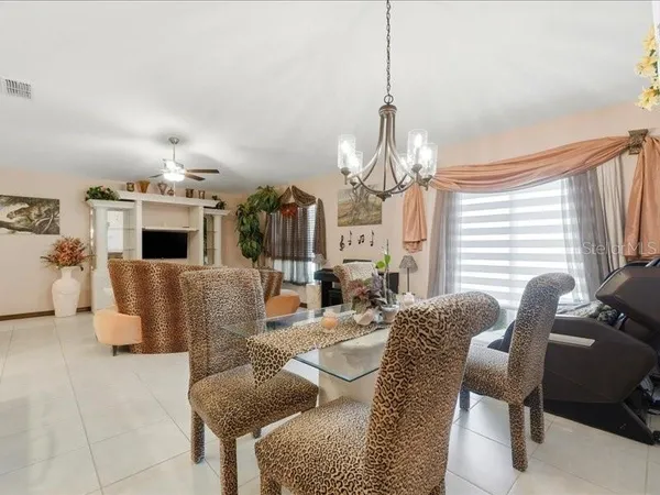 a living room with furniture a fireplace and a chandelier