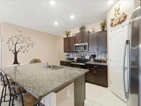 a kitchen with refrigerator and cabinets