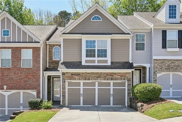 a front view of a house with a yard