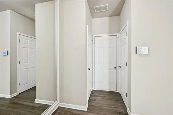a view of a hallway with wooden floor