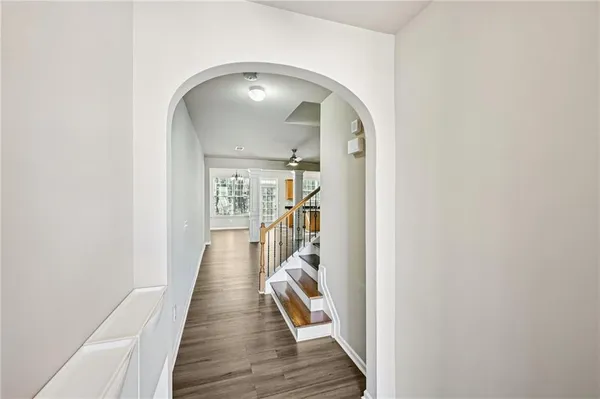 a view of a hallway with wooden floor and staircase