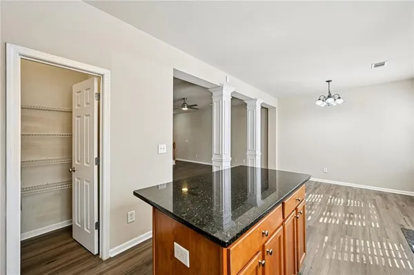a kitchen with granite countertop a sink and refrigerator