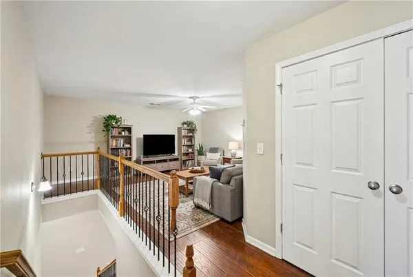 a view of a livingroom with wooden floor and windows