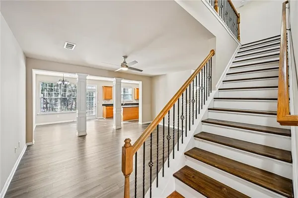 a view of entryway and hall with wooden floor
