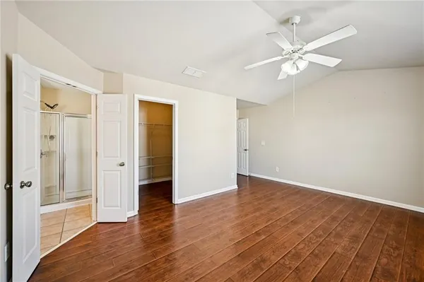 a view of an empty room with wooden floor