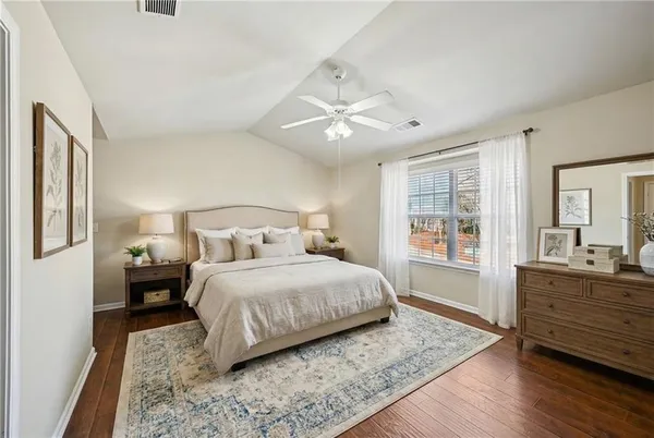 a bedroom with a large bed and a window