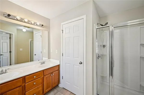 a bathroom with double vanity sink and a mirror