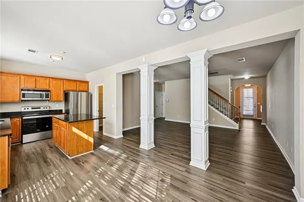 a kitchen with stainless steel appliances granite countertop a stove and a refrigerator
