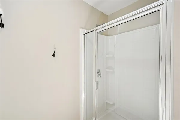 a bathroom with a glass shower door