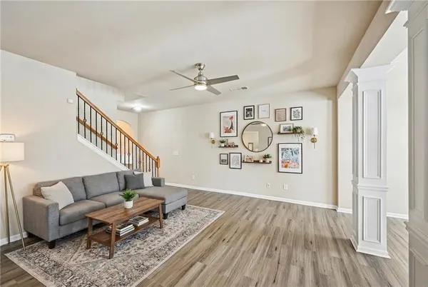 a living room with furniture and wooden floor