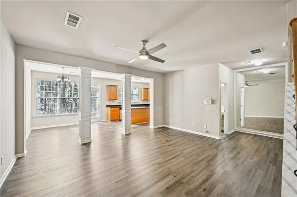 wooden floor in an empty room with a window
