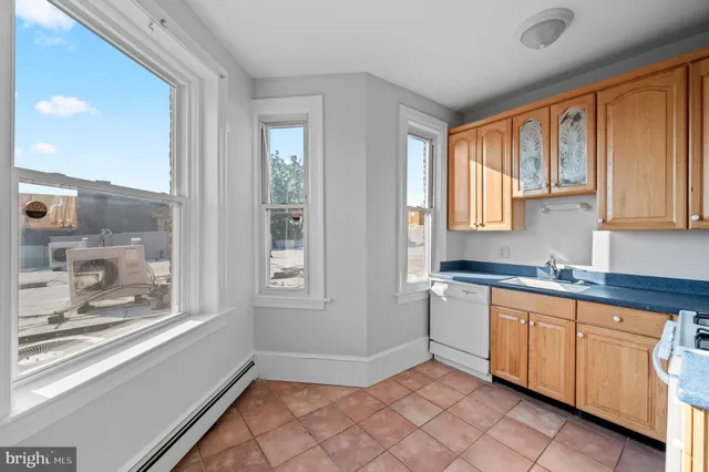 a view of a kitchen with sink cabinets and outdoor space