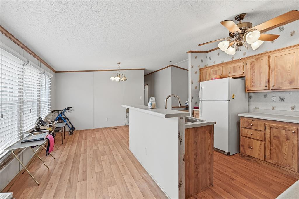 227 Sheryl Lane Denison, TX 75021 - Photo 15 of 37 a kitchen that has a lot of cabinets a sink and appliances in it
