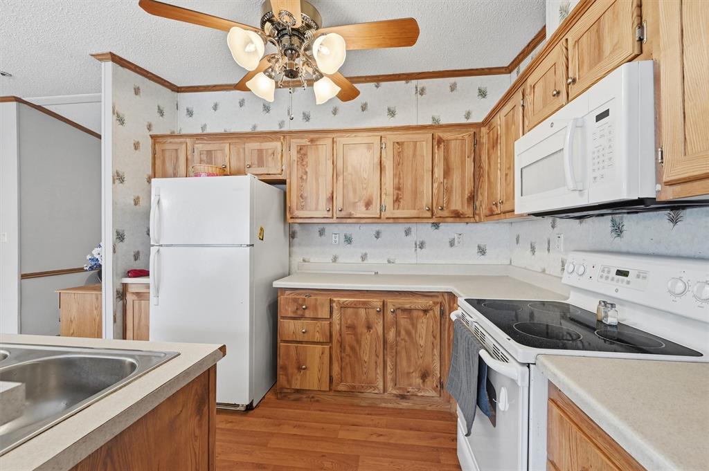 227 Sheryl Lane Denison, TX 75021 - Photo 16 of 37 a kitchen with a sink a stove and refrigerator