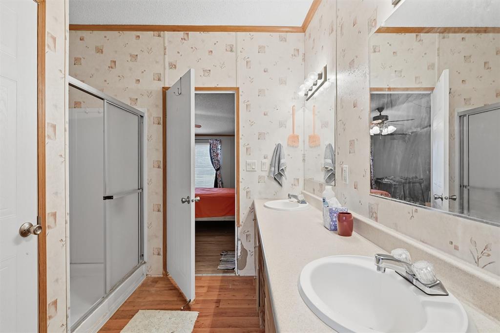227 Sheryl Lane Denison, TX 75021 - Photo 19 of 37 a en suite bathroom with a sink and a mirror
