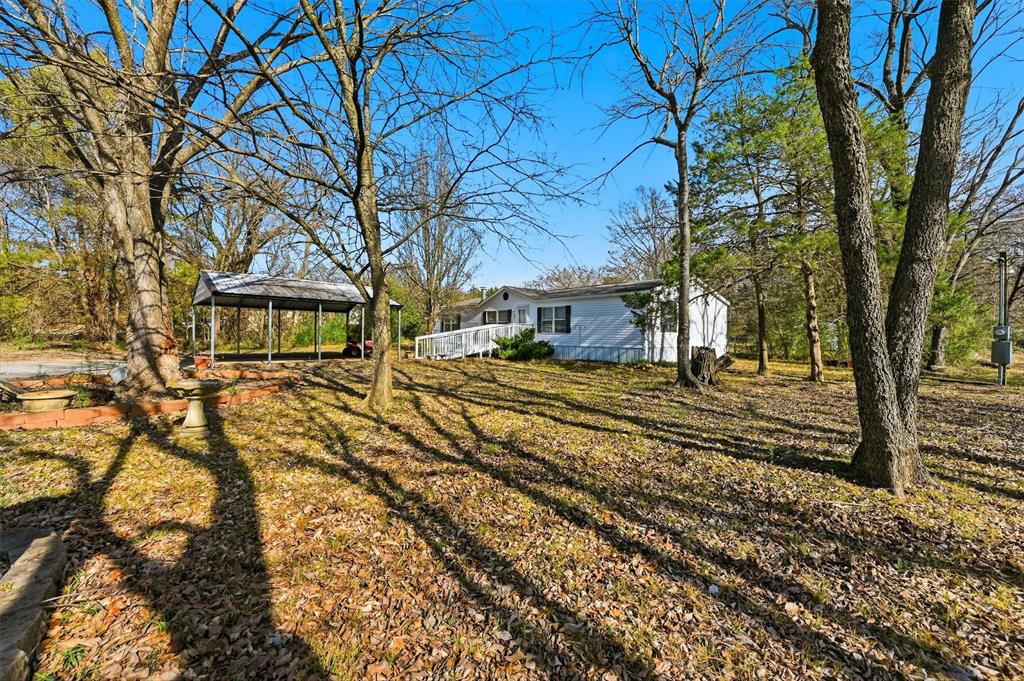 227 Sheryl Lane Denison, TX 75021 - Photo 2 of 37 a view of a yard with a tree